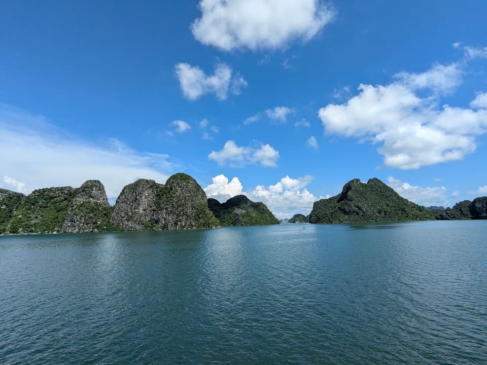 Limestone islands rising from blue water in Ha Long Bay