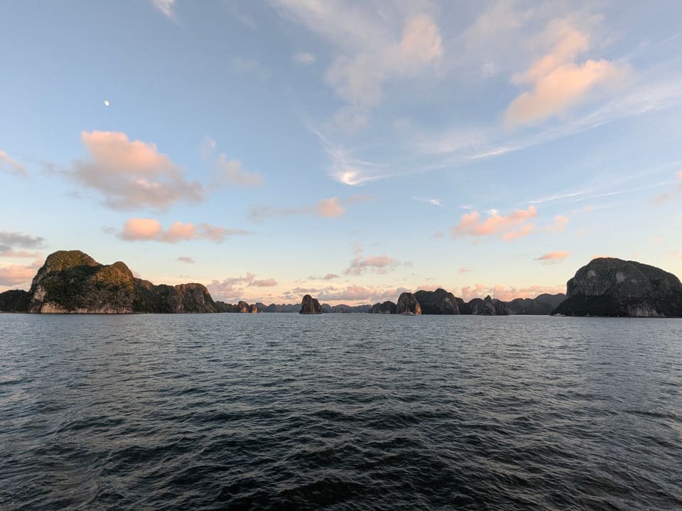 Pastel sunset above the limestone islands of Ha Long Bay