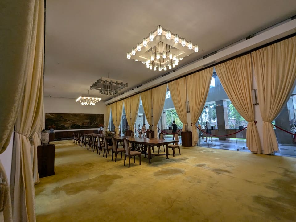 Geometric chandeliers and long reception tables inside Independence Palace