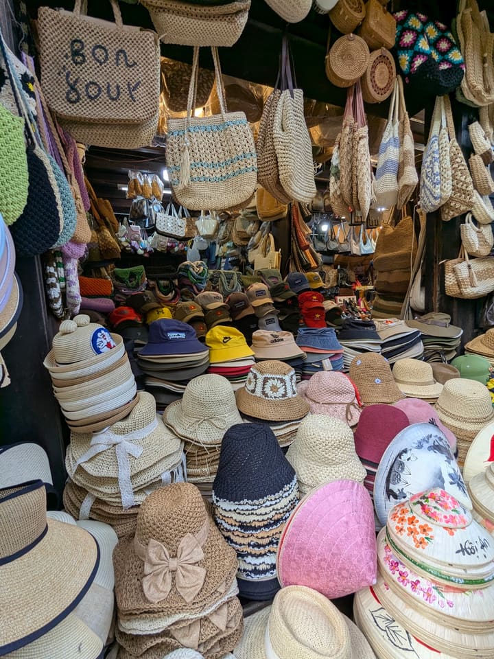 Baskets of conical hats and woven goods in Hoi An market