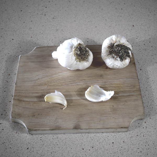 Removing cloves from garlic head and spacing out on cutting board