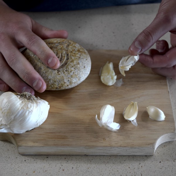 Easily peeling away skin from garlic following smash from the rock