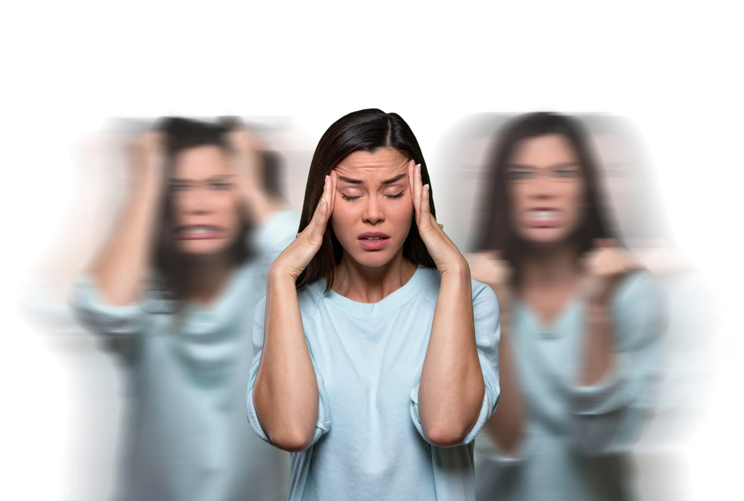 Woman experiencing intense mental distress with blurred emotional expressions in the background, representing psychosis