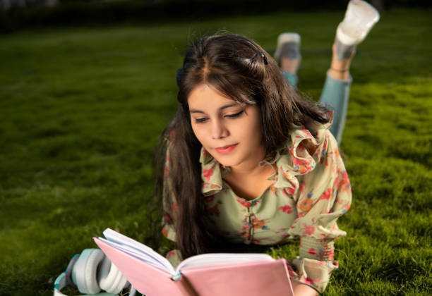 Young woman reading a book in a garden, smiling with hope — representing healing through books on depression.