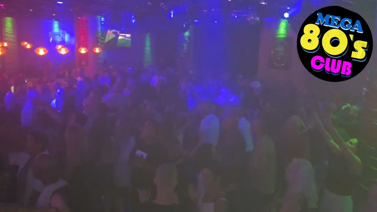 A high energy video clip showing a professional DJ performing at a crowded club.