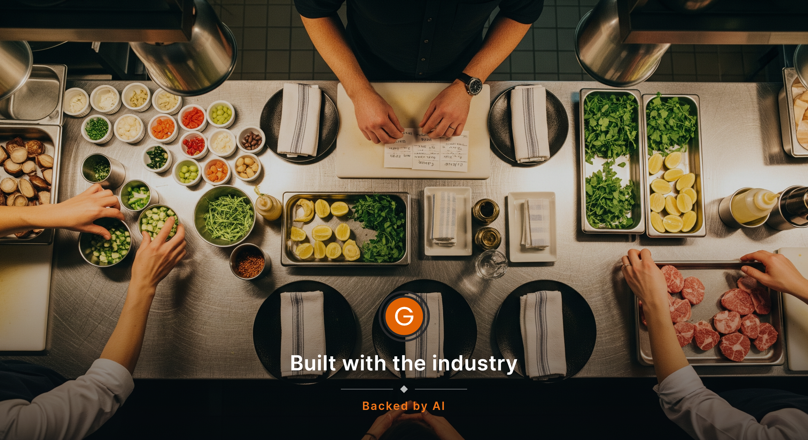 Overhead view of a stainless prep station just before service, with ramekins, garnish trays, folded side towels, and a manager’s hands sorting handwritten shift notes beside neatly arranged place settings while two staff hands reach in from opposite sides to grab mise en place. Warm kitchen light, r