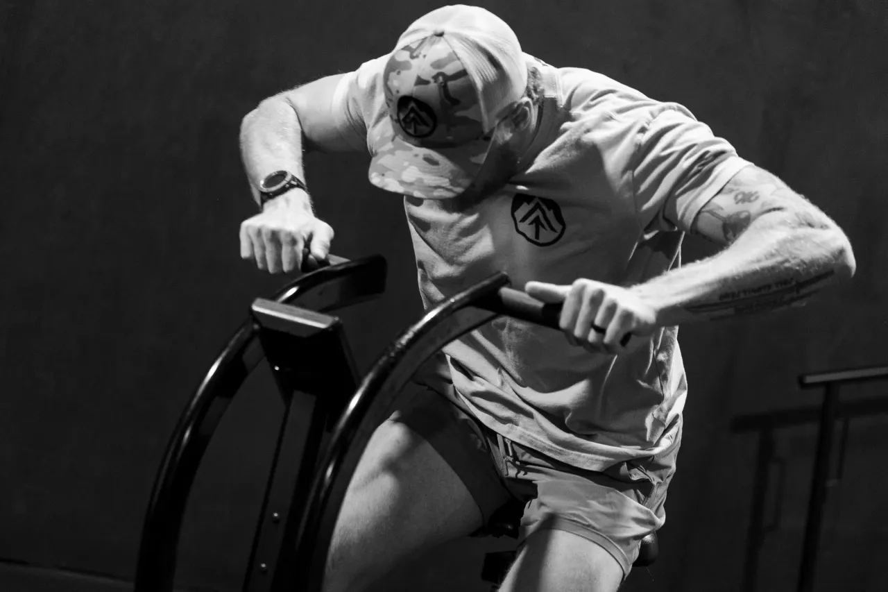 WorkBuilt athlete driving a conditioning bike in the gym