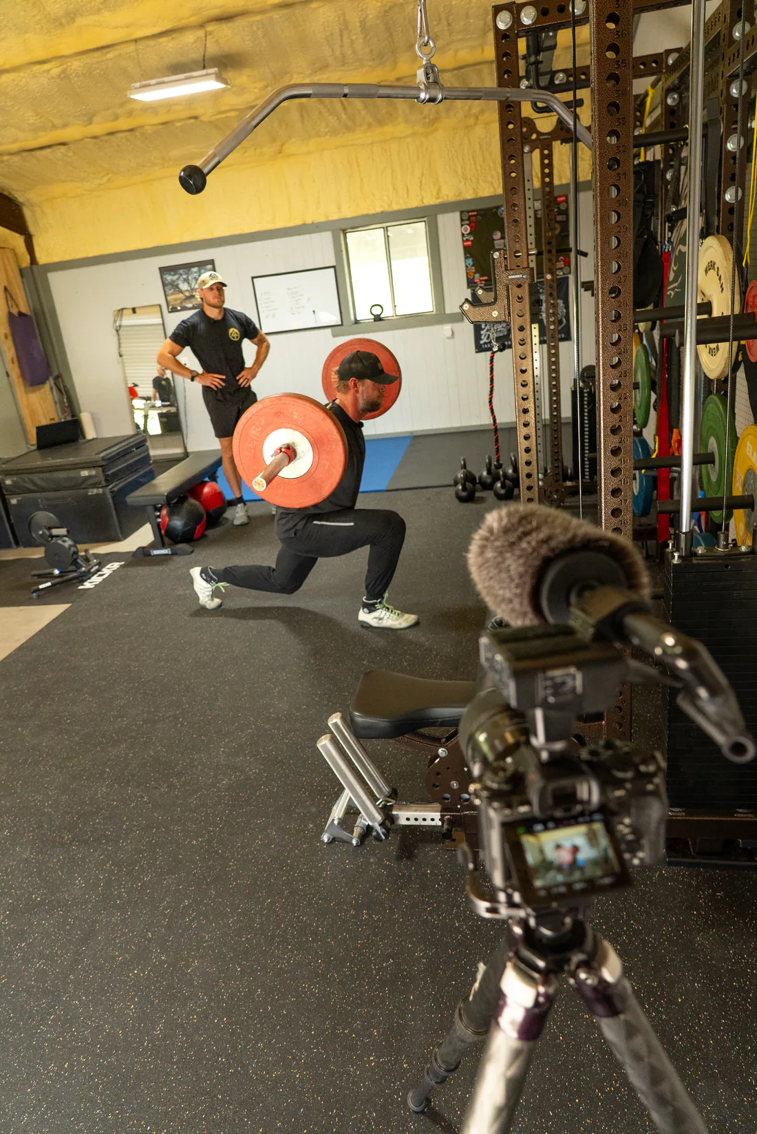 WorkBuilt athlete performing a barbell lunge in the gym
