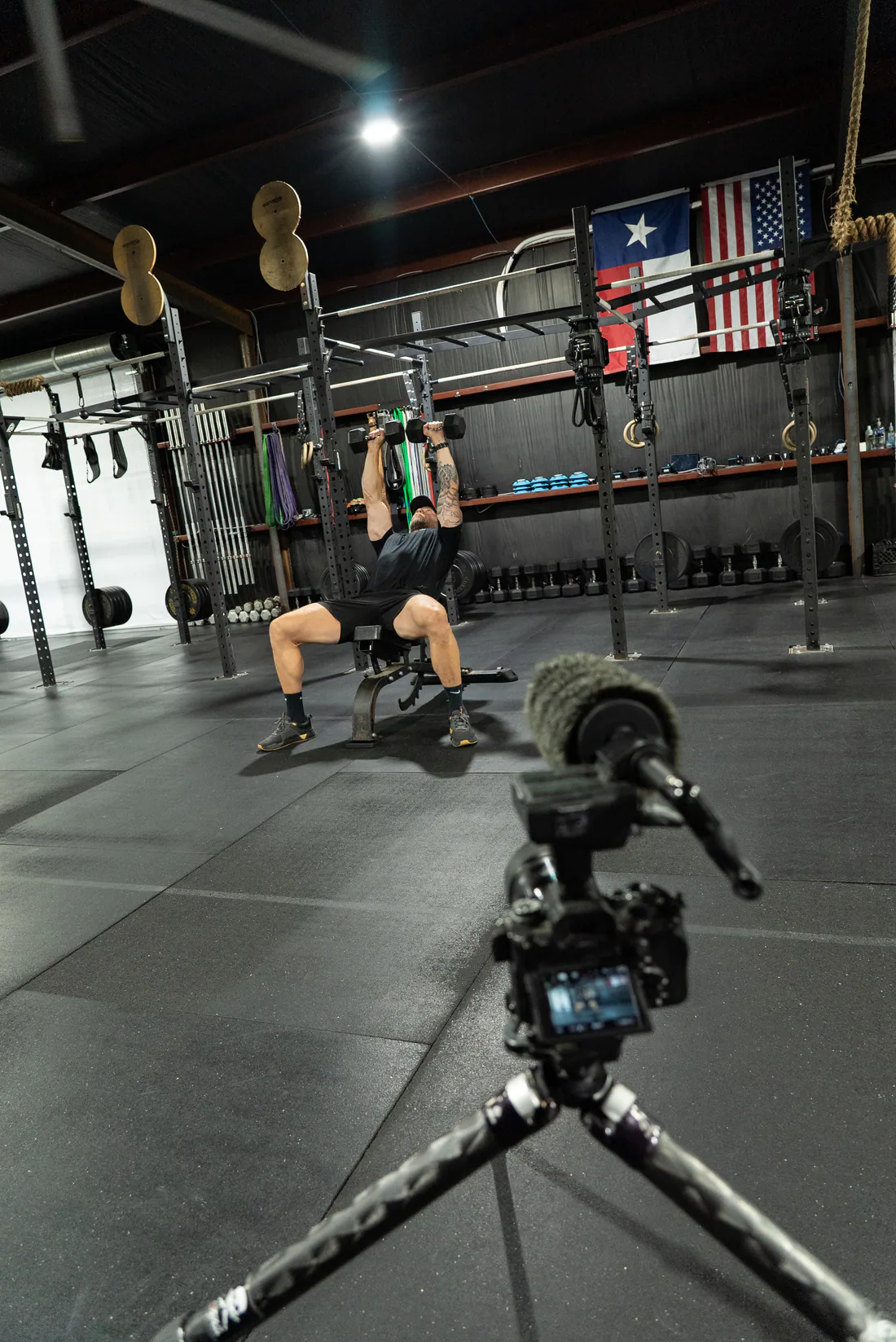 Athlete performing a dumbbell press during a WorkBuilt session