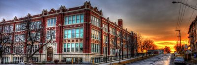 Lewis and Clark High School brick exterior beside a street at sunset
