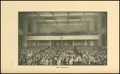 Yearbook photograph captioned Girls Federation, showing an audience on the main floor and balcony