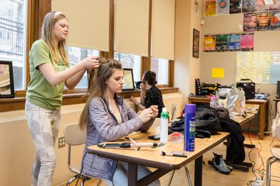 Student fixing hair of another student