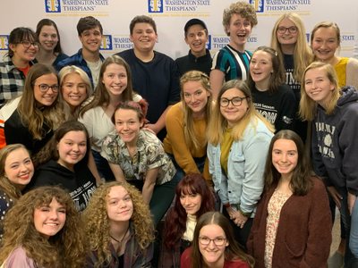 Tiger Drama students posing together in front of a Washington State Thespians backdrop