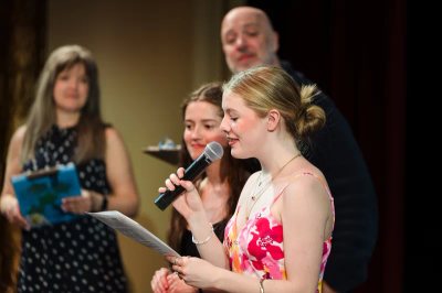 A Tiger Drama student speaking during a Thespian induction celebration