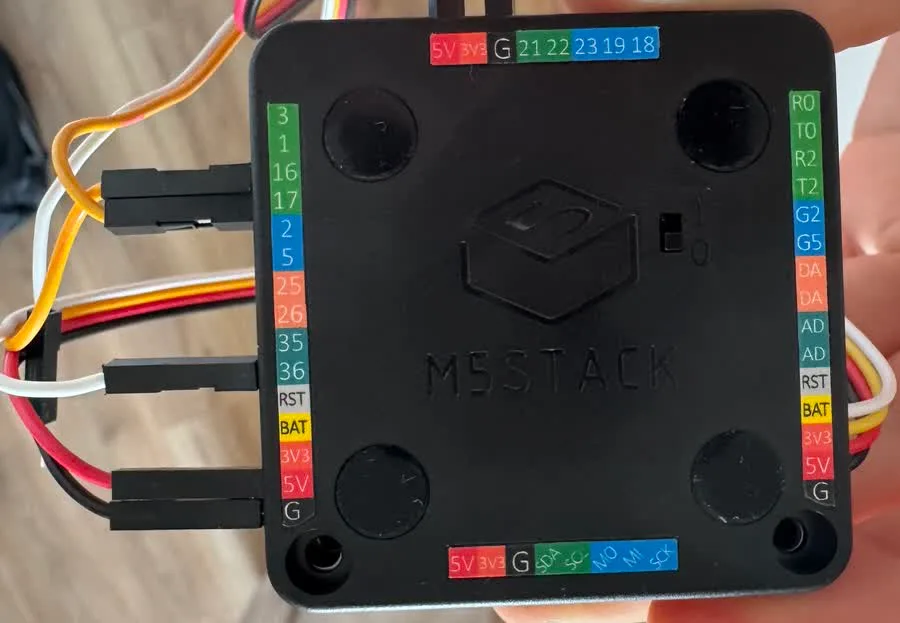 The underside of the M5Stack controller, every pin labelled in colour coded strips, with jumper wires pushed onto the G16, G17 and G36 headers