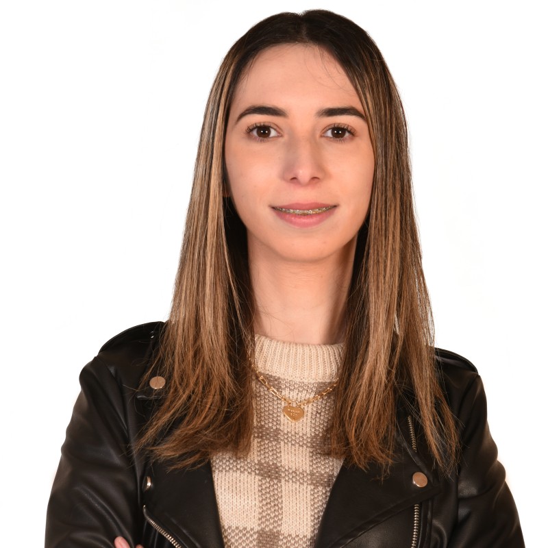 Portrait of Nisrine, a caucasian woman smiling at the camera.