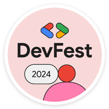 วงกลมสีชมพูที่มีเส้นขอบสีขาว ภายในมีไอคอนรูปคนสีแดง ข้อความ &quot;DevFest 2024&quot; และโลโก้นักพัฒนาซอฟต์แวร์ Google