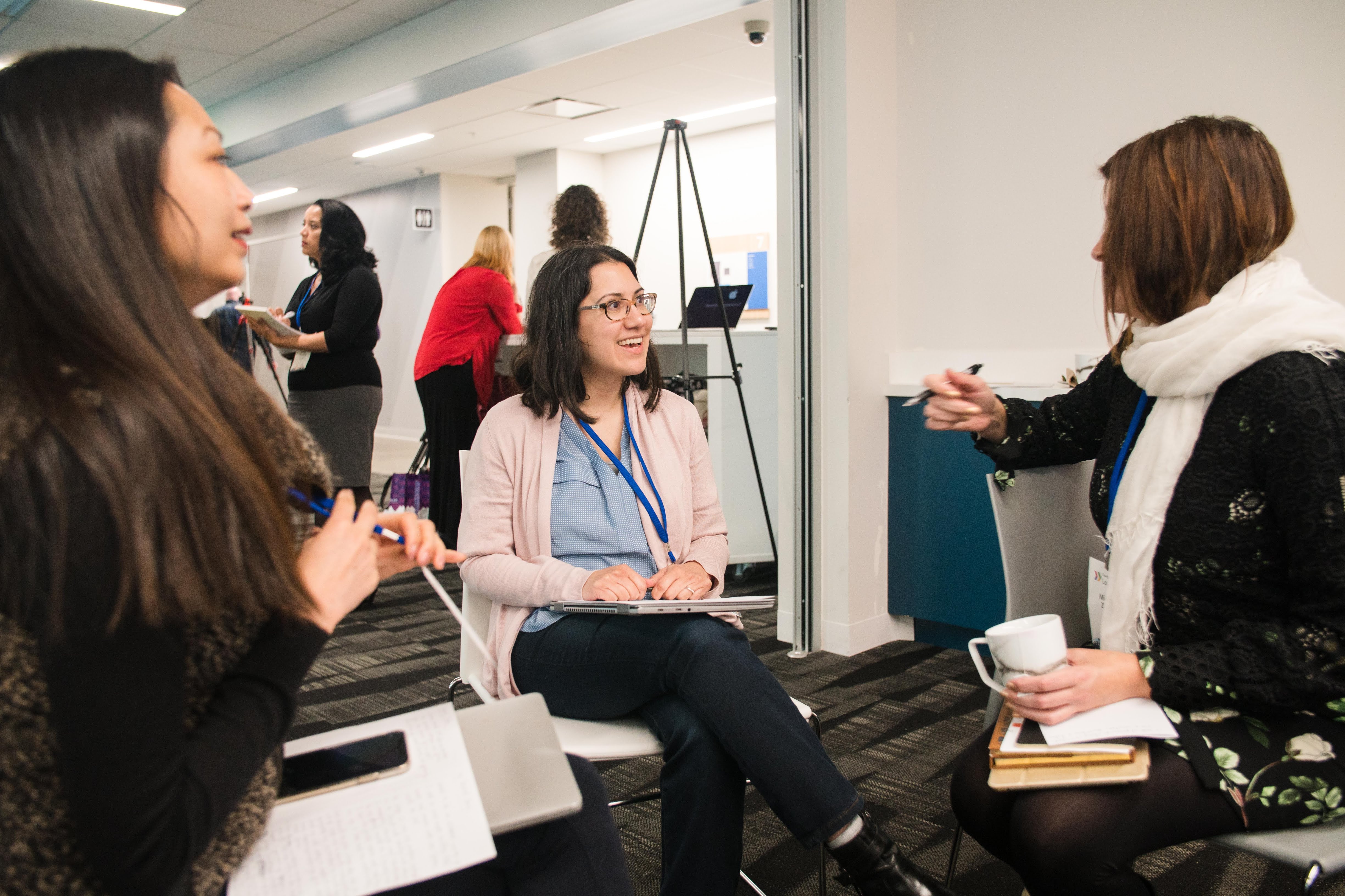 A diverse group of women engaged in a conversation.