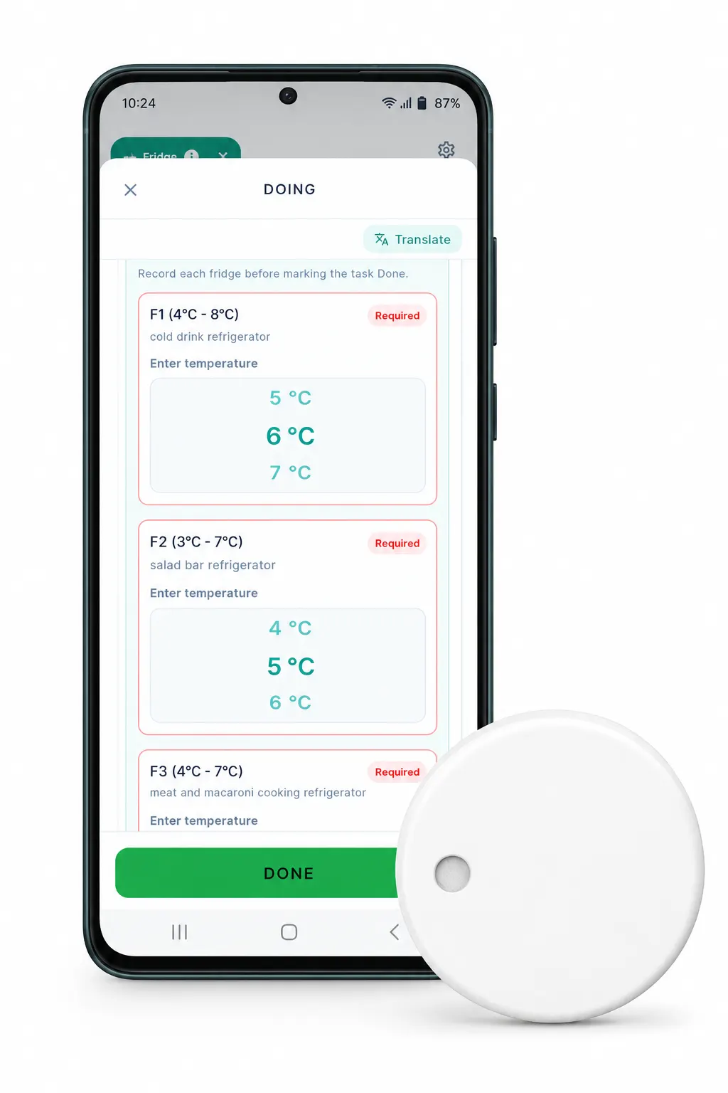 A wireless temperature sensor beside a phone showing the temperature reading in the Loopapa app