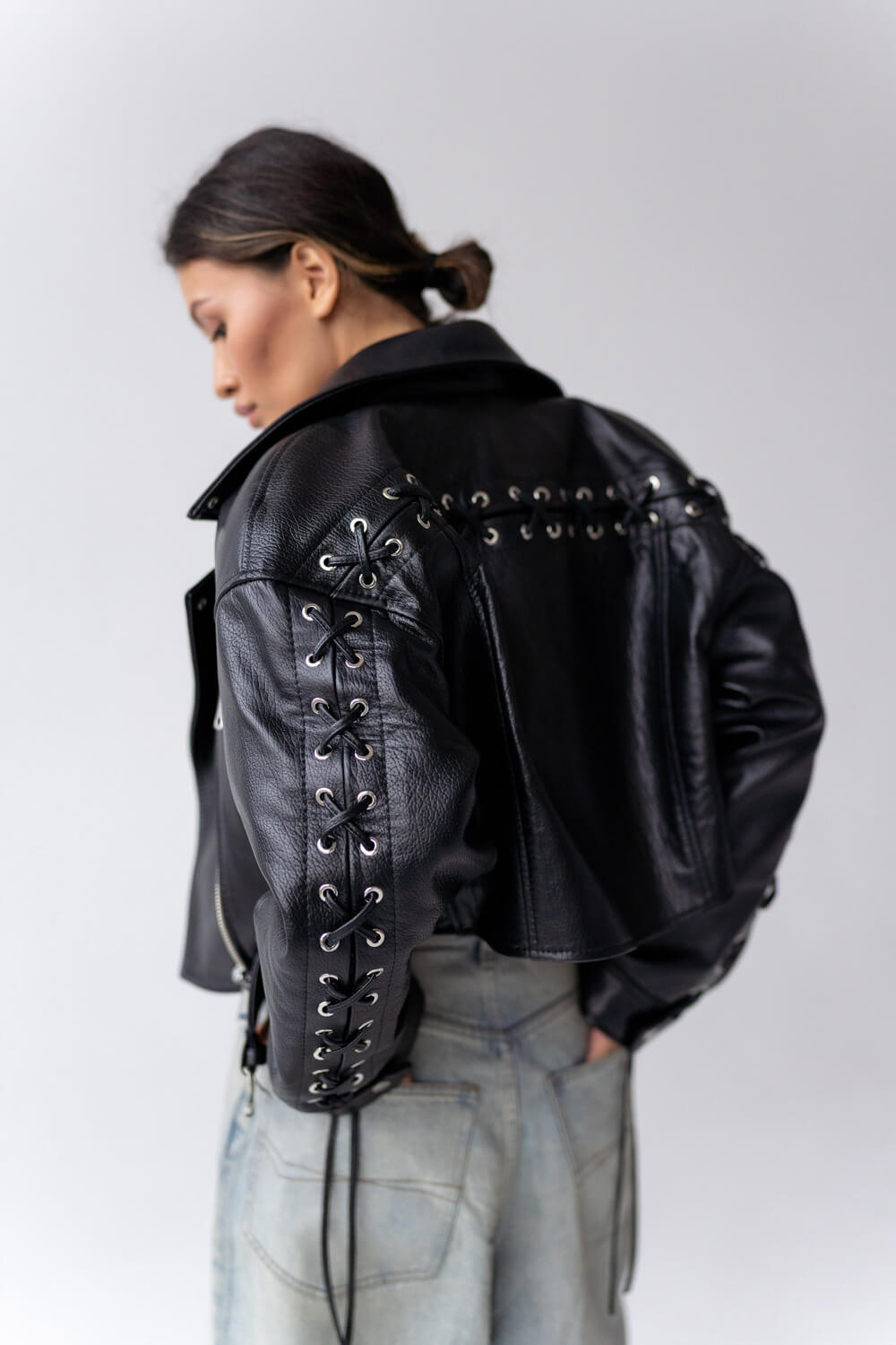 Jacket with lacing on the sleeves and back