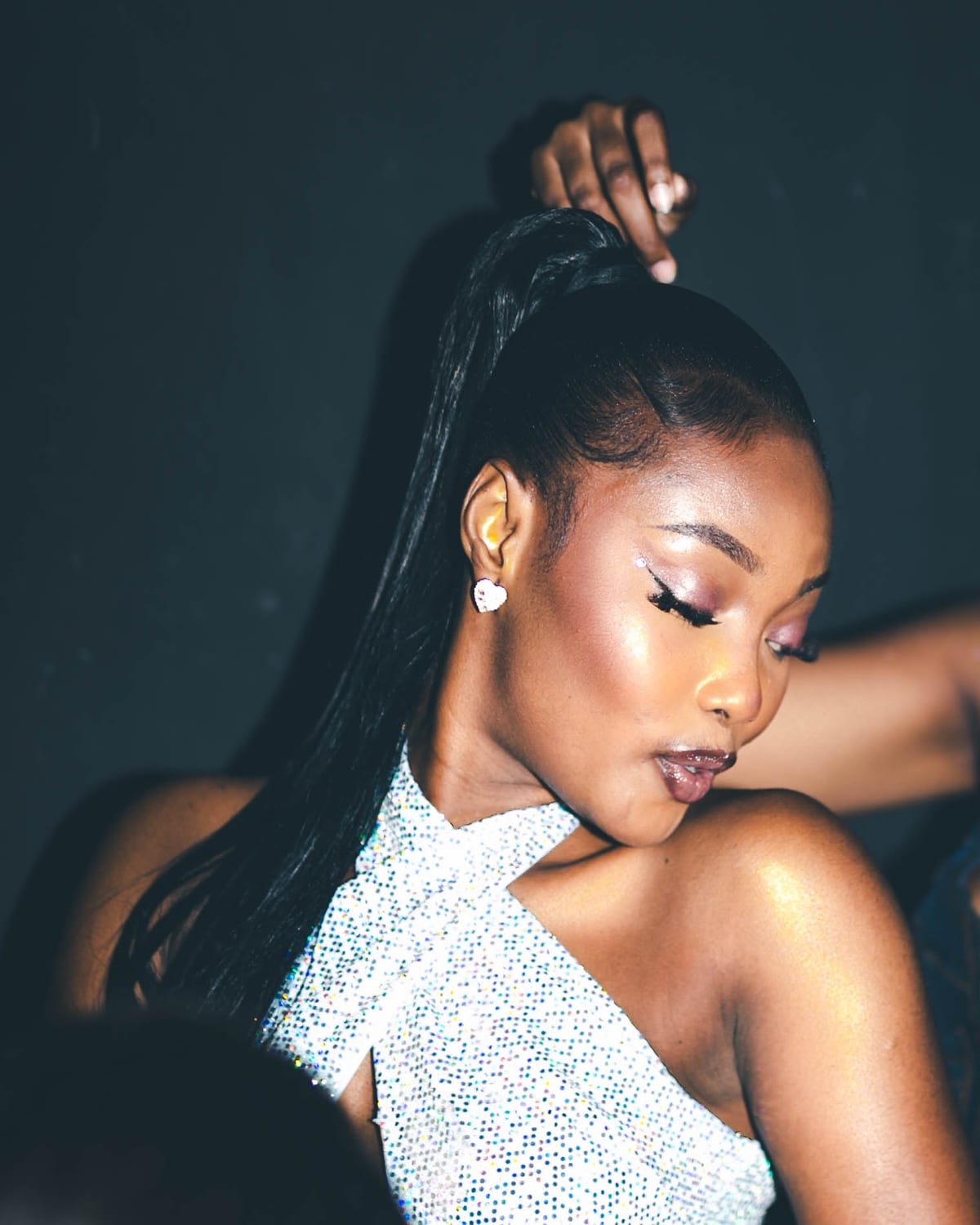 A woman wearing a sparkling white outfit at G+ Nightclub