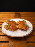 Bochechas de peixe empanadas com glacê de maracuja
