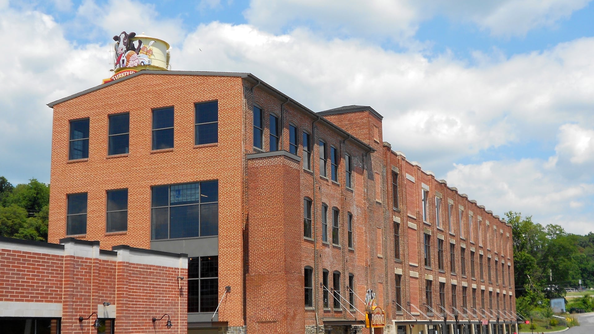 Historic red-brick factory building adaptively repurposed into a vibrant commercial visitor destination