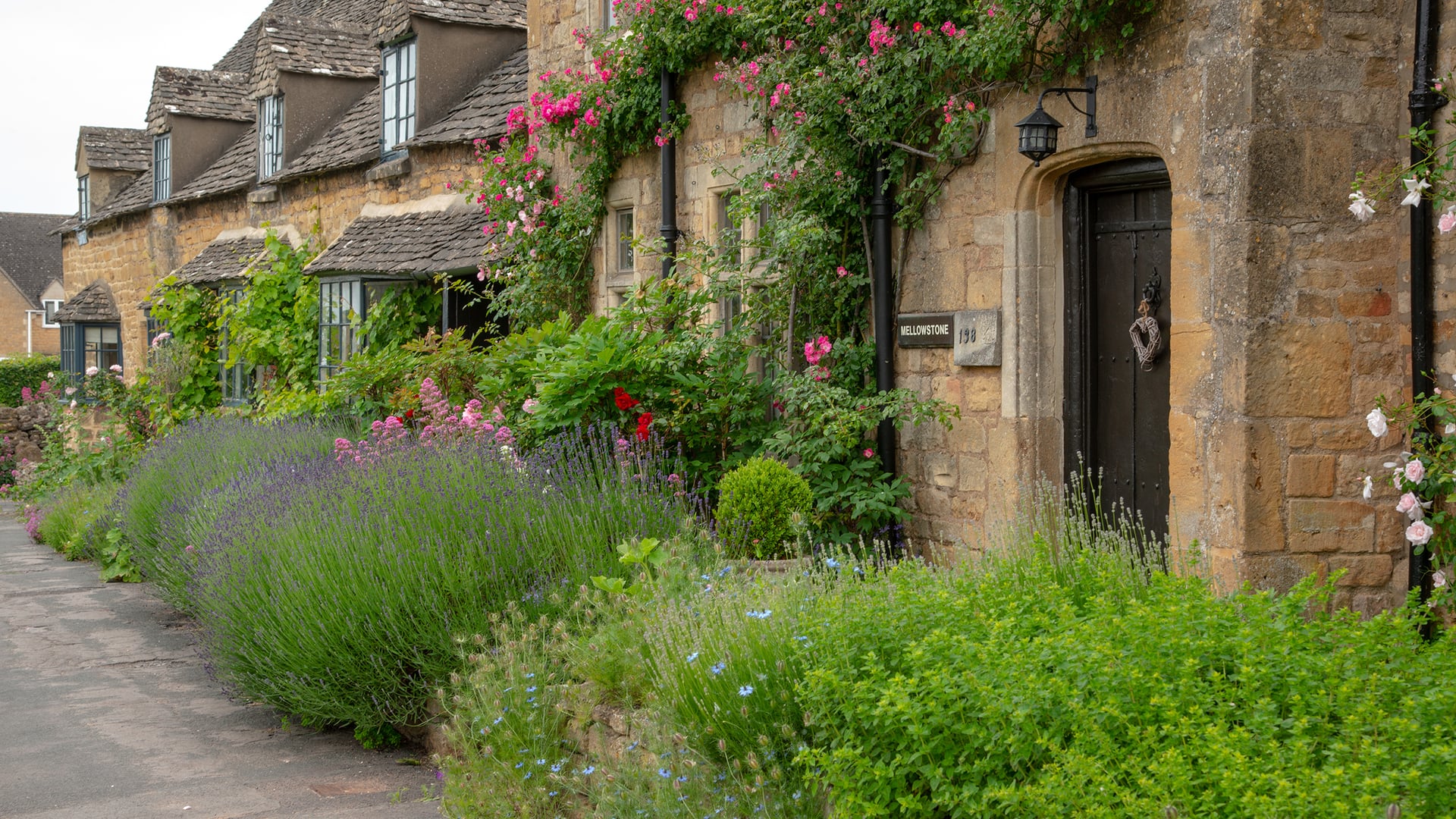 Broadway honey-colored Cotswold stone inn and village high street demonstrating regional boutique hotel appeal