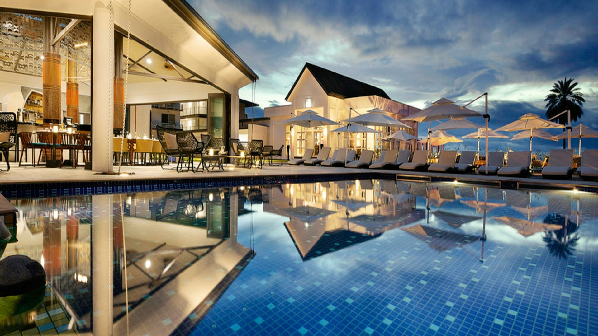 Cantilevered infinity pool overlooking pristine tropical valley reflecting institutional investment quality