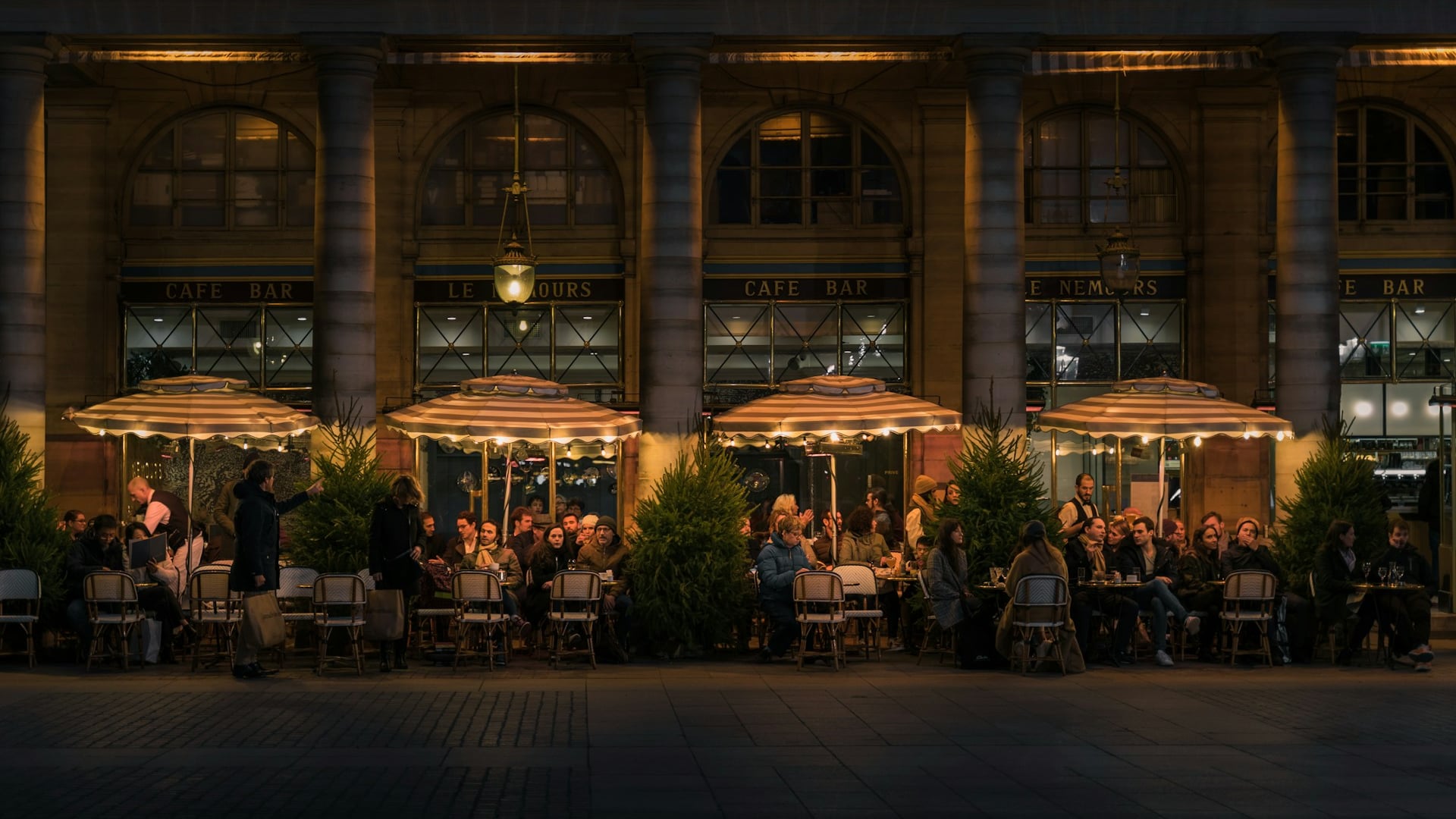 Parisian outdoor bistro terrace street with bustling café culture creating a destination corridor