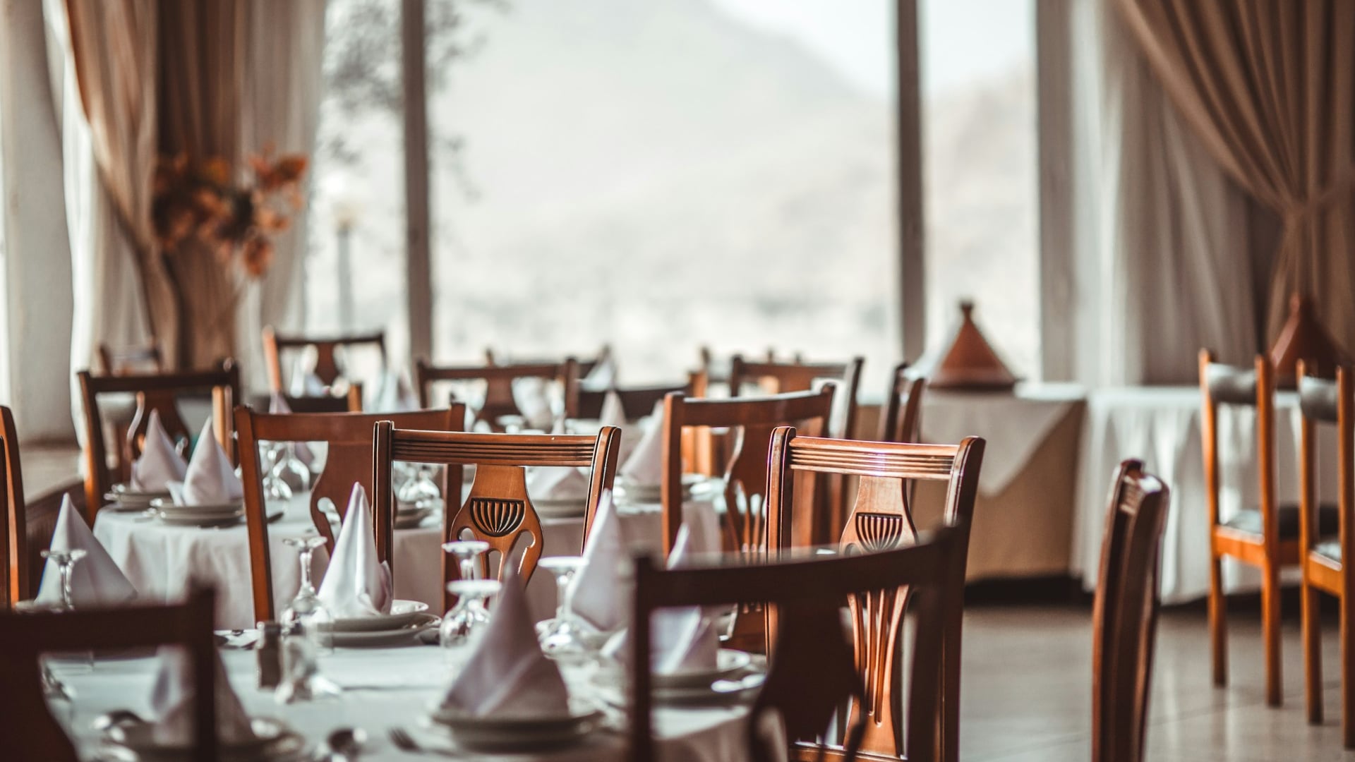Striking double-height restaurant dining room anchoring a mixed-use commercial development