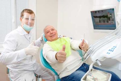 senior with oral surgeon getting procedure done