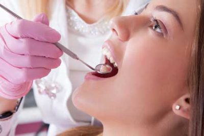 A woman receiving an oral exam.