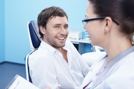 man with dentist discussing porcelain veneers