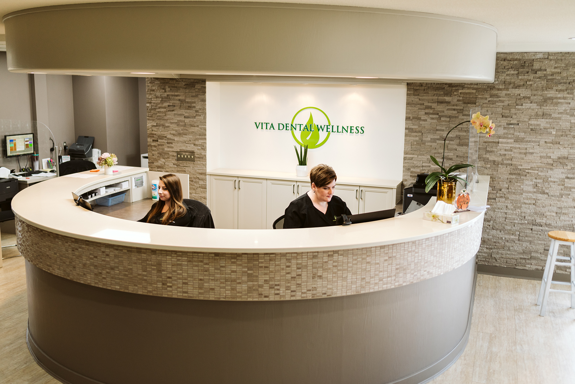 Receptionists at the front desk of Vita Dental Wellness.