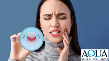 A woman holding her mouth in pain.