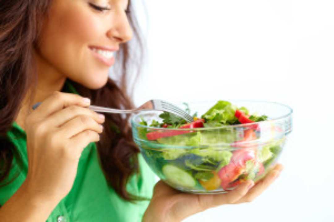 a woman eating a salad