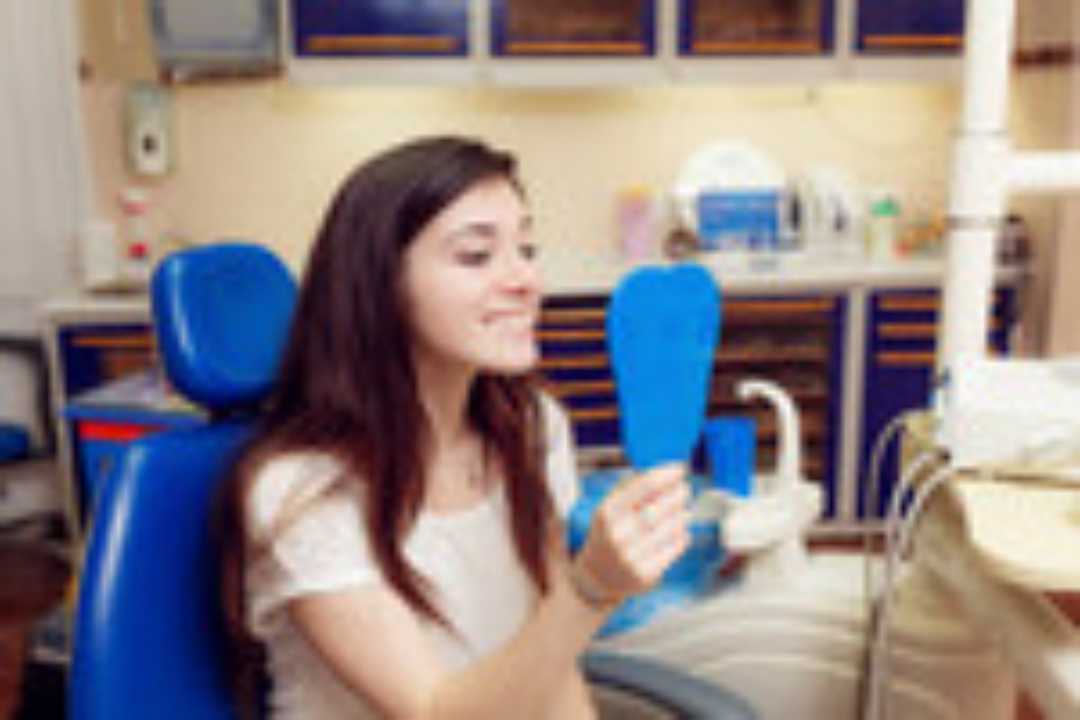 woman looking at her newly cleaned smile