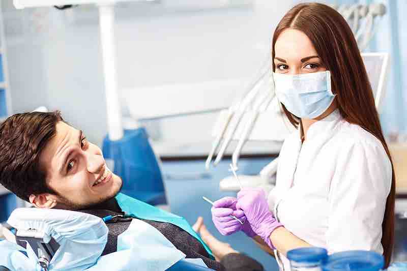 A dentist with her patient before a cleaning.