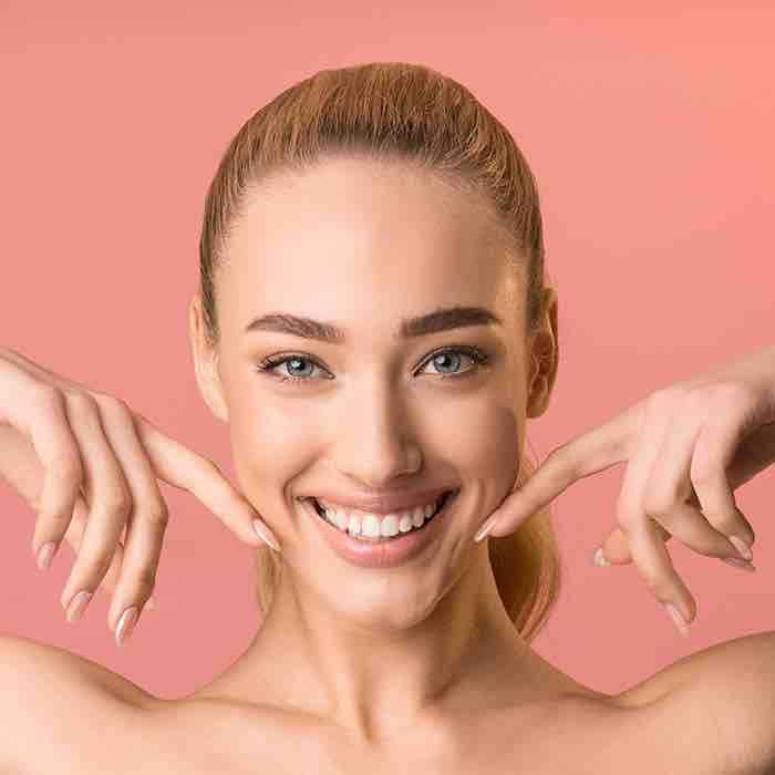 A woman smiling with perfect teeth.