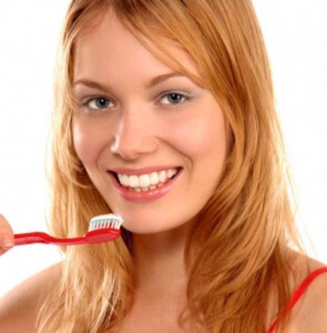 woman about to brush her teeth