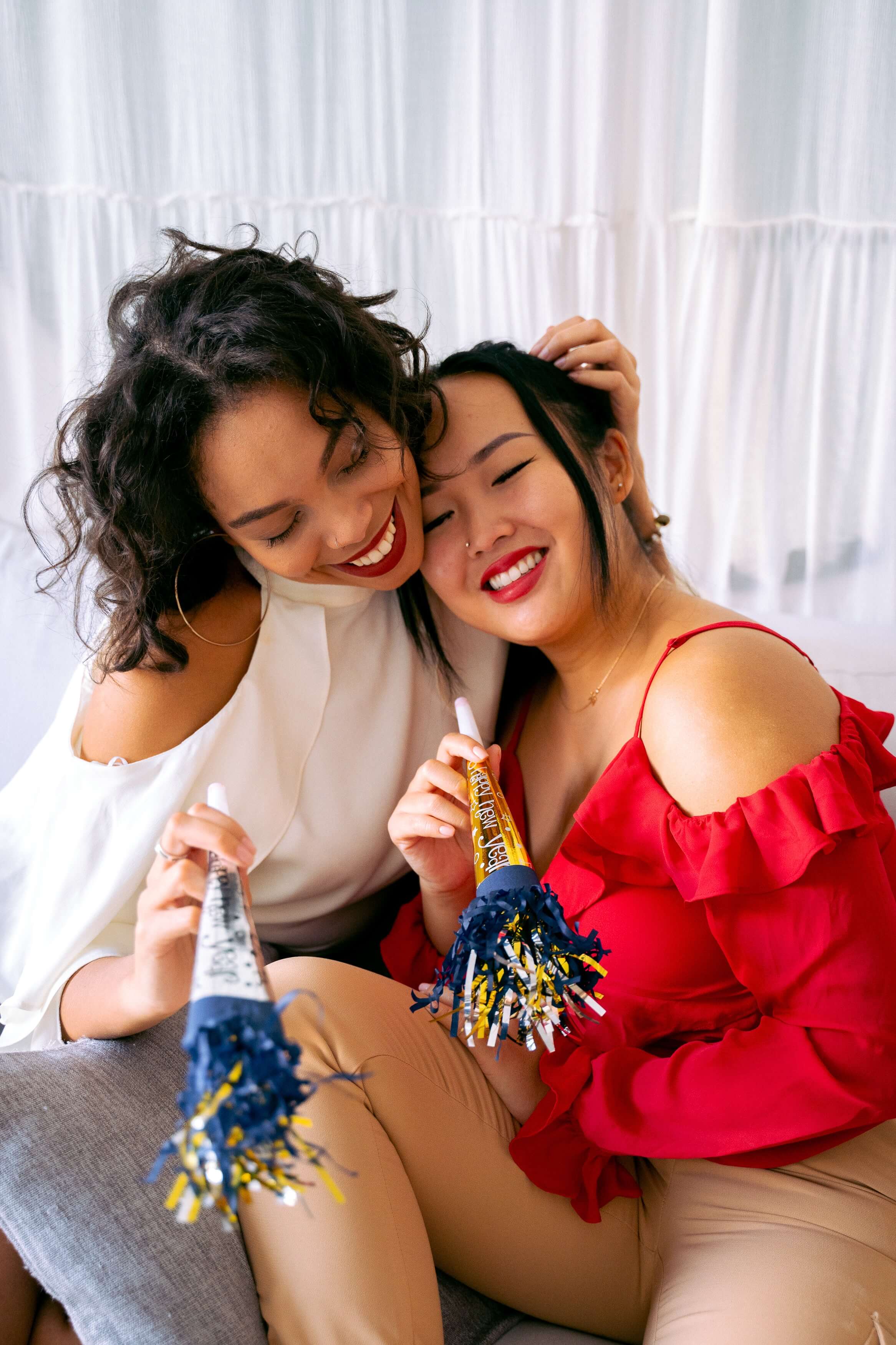 two women smiling while embracing eachother