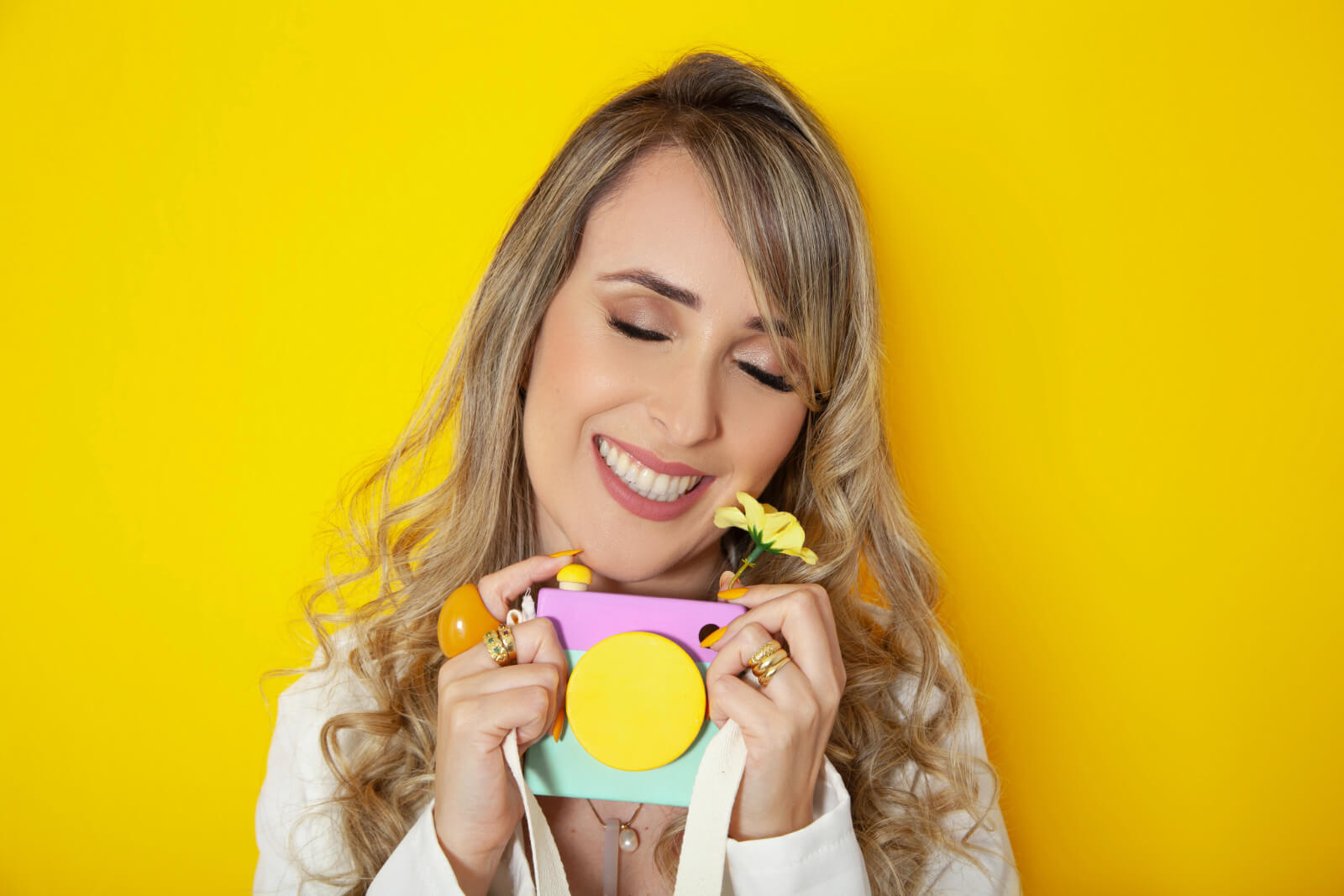 woman smiling while holding a camera