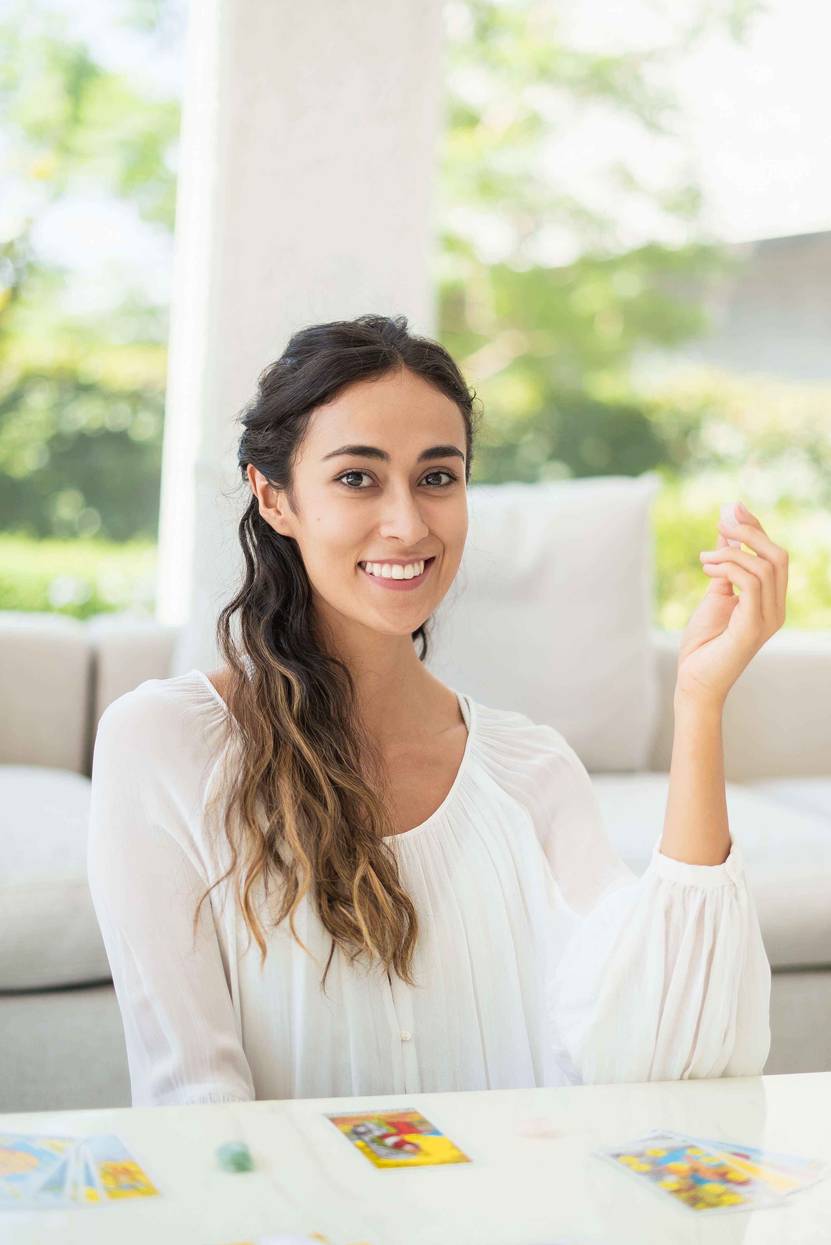 woman sitting at a table and smiling 