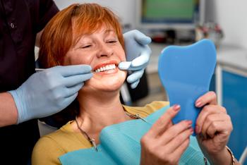 dentist showing women her nice teeth