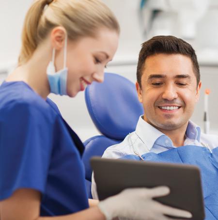 dentist showing client tablet