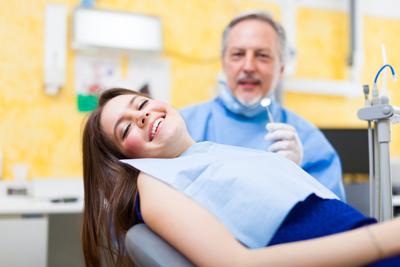 women patient smiling in dentist chair 