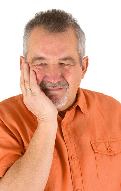 man suffering from jaw pain