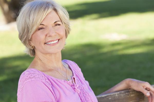 mature woman sitting on a bench in the park