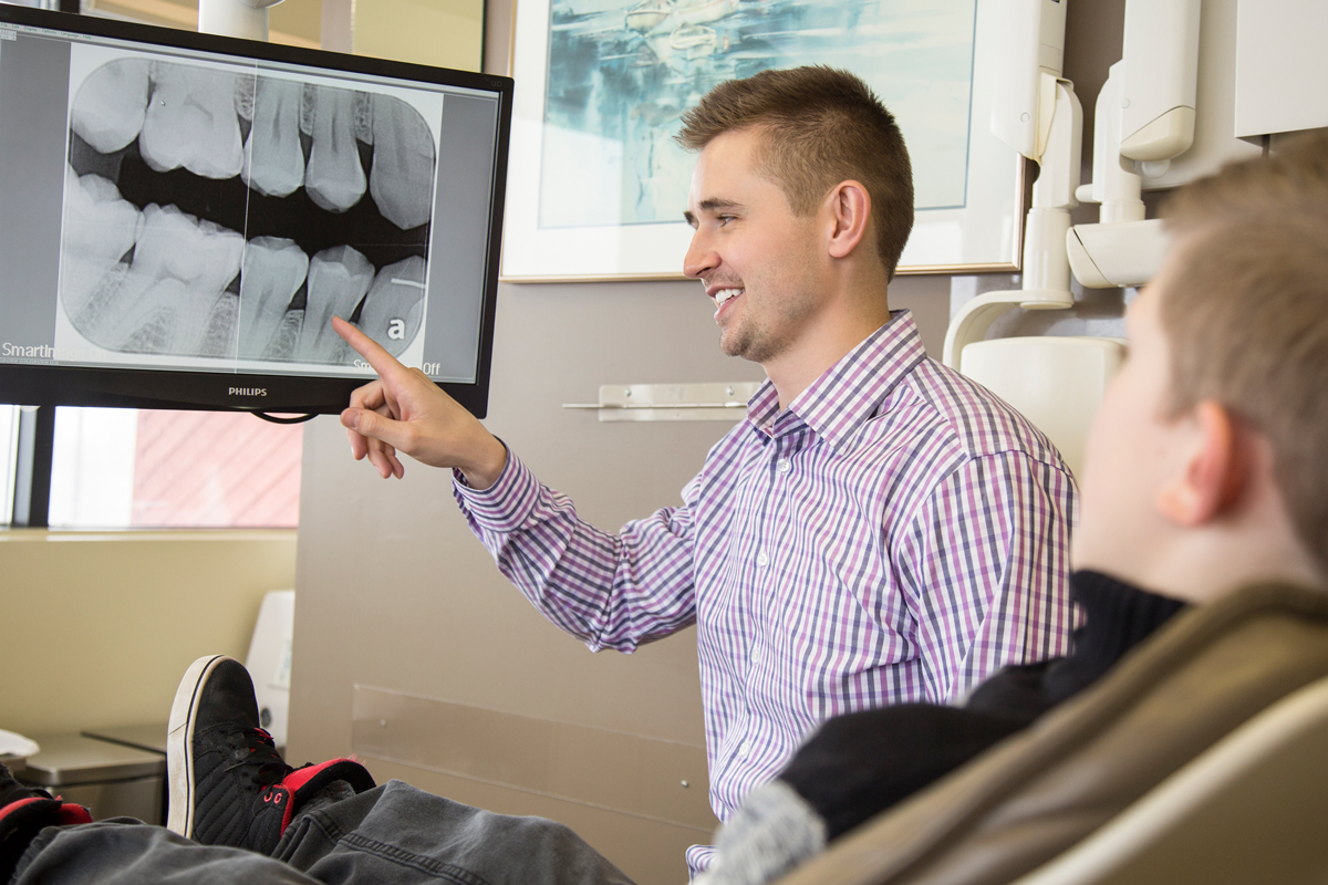 grande prairie dentist looking at xrays